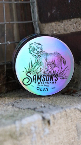 3 oz Matte Finish Clay Pomade with new Bench-Leg logo perched on a concreate ledge.