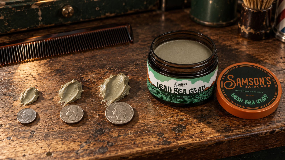 A jar of Samson's Dead Sea Clay on a barbershop counter beside a dime, nickel and quarter, each next to a matching scoop of clay.