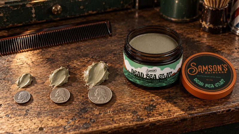 A jar of Samson's Dead Sea Clay on a barbershop counter beside a dime, nickel and quarter, each next to a matching scoop of clay.