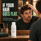 Man checking his hair in the mirror with Samson's Volumizing Matte Powder: if your hair goes flat, lift at the roots