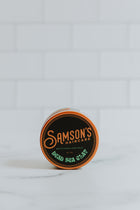 4 oz Dead Sea Clay on its side to showcase the top of the container against a white background.