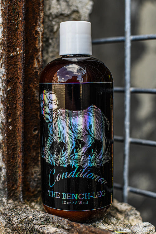 12 oz Premium Conditioner with new Bench-Leg logo, displayed on a weathered, rusted ledge.