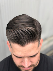 Adam displaying the side part hairstyle achieved using the hair pomade.